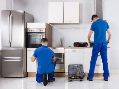 Two Men Checking Induction Stove And Sink Pipe
