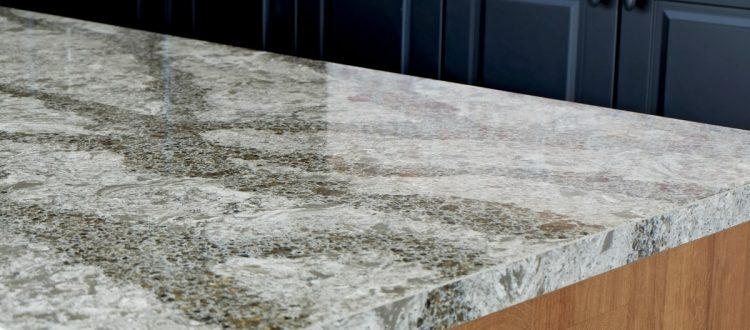 Close-up of a modern kitchen island featuring a polished quartz countertop with intricate patterns.