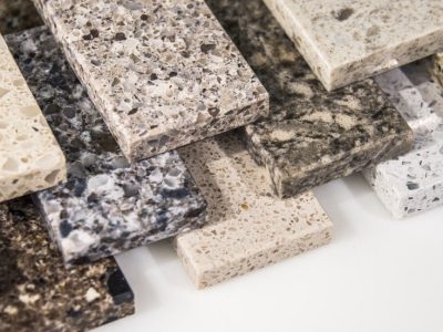A variety of quartz and quartzite countertop samples showcasing different colors and textures.