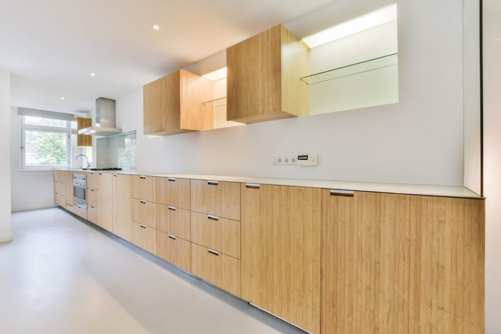 Modern kitchen with custom light wood cabinet doors and minimalist design.