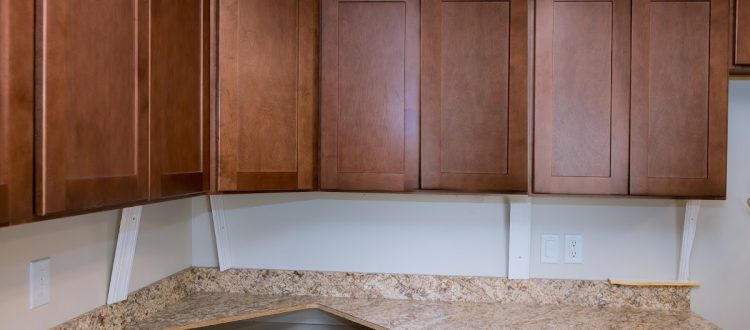 Kitchen with custom wooden cabinet doors and marble countertop.