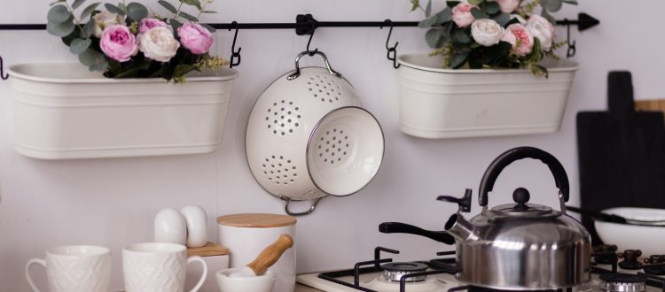 Stainless steel kettle on stove with flowers
