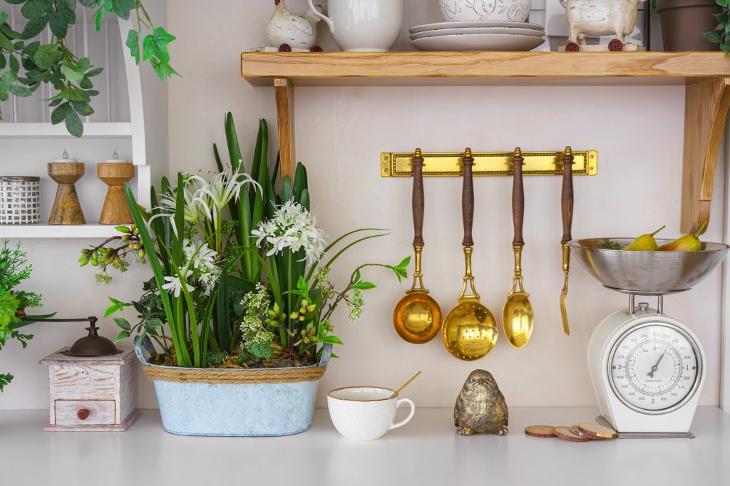 Kitchen counter with flowers and brass utensils