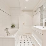 White bathroom with bathtub and sink