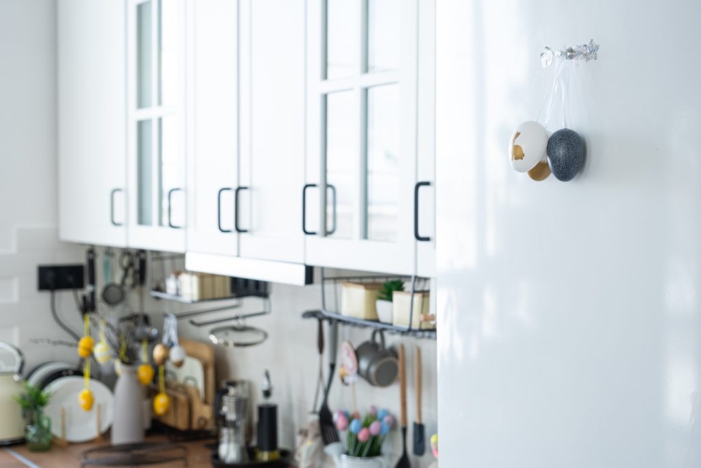 White kitchen with decorated refrigerator and utensils
