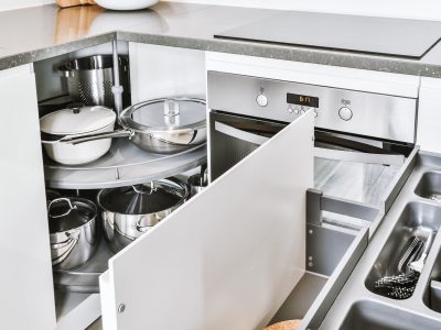 Open kitchen cabinet with stainless steel cookware