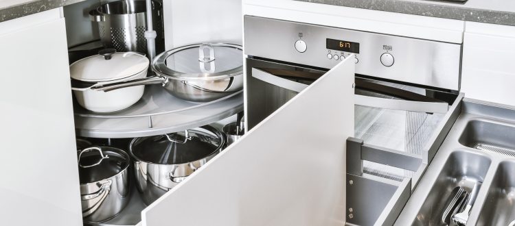 Open kitchen cabinet with stainless steel cookware