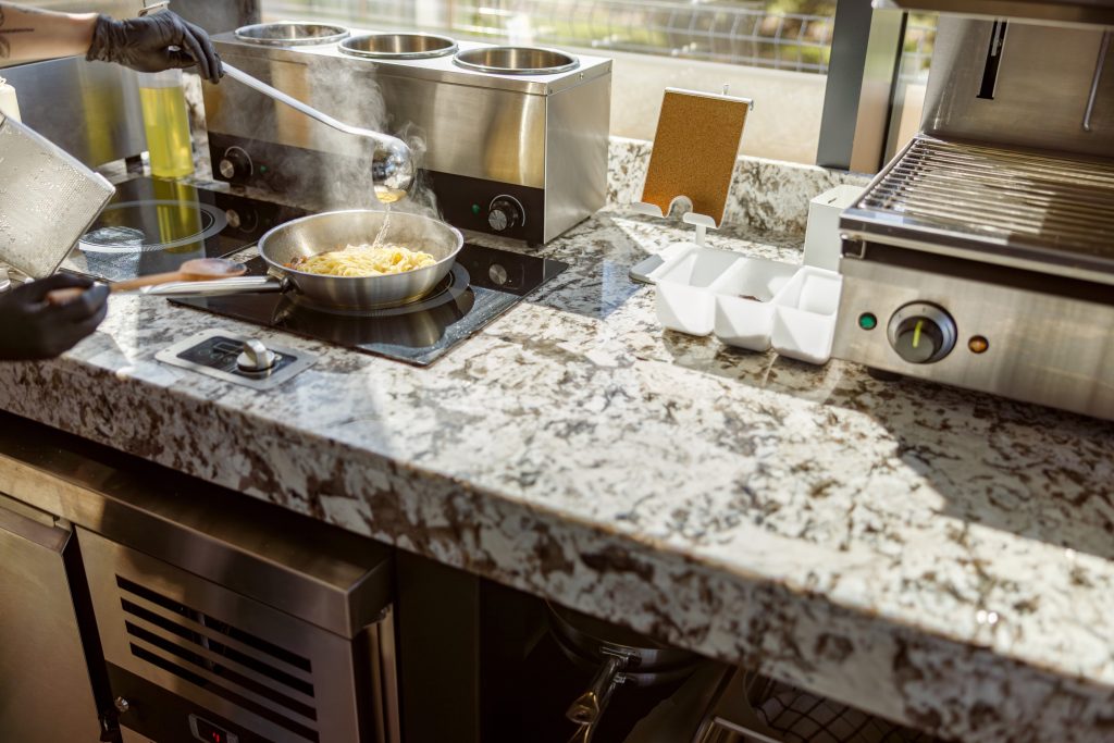 Chef cooking steaming pasta on stove