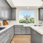 Gray kitchen cabinets with window view