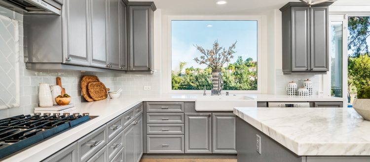 Gray kitchen cabinets with window view