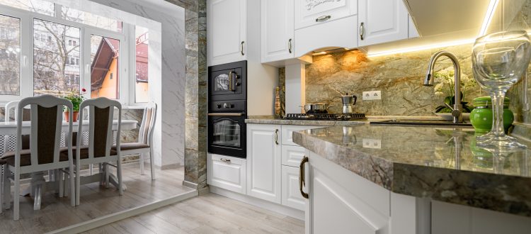 White kitchen with marble countertops and dining area
